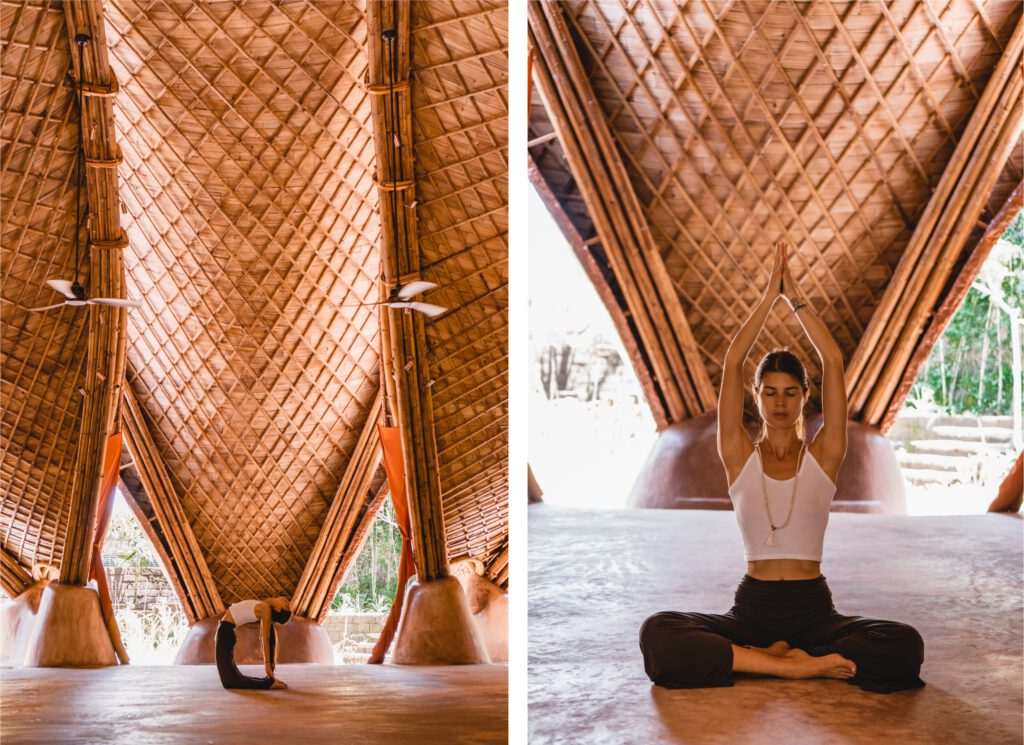 A woman practicing yoga in a bamboo shala in Ubud, Bali, surrounded by warm light.